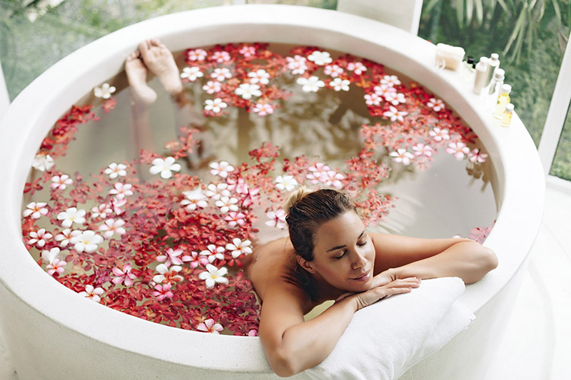 Luxury hotel suite with welcome amenities and floral arrangement