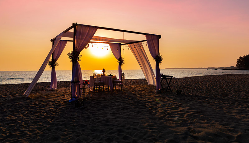 Romantic beach picnic set up at night under the stars