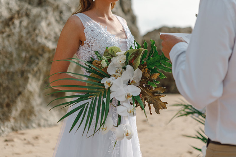 Outdoor vow renewal ceremony decorated with tropical flowers